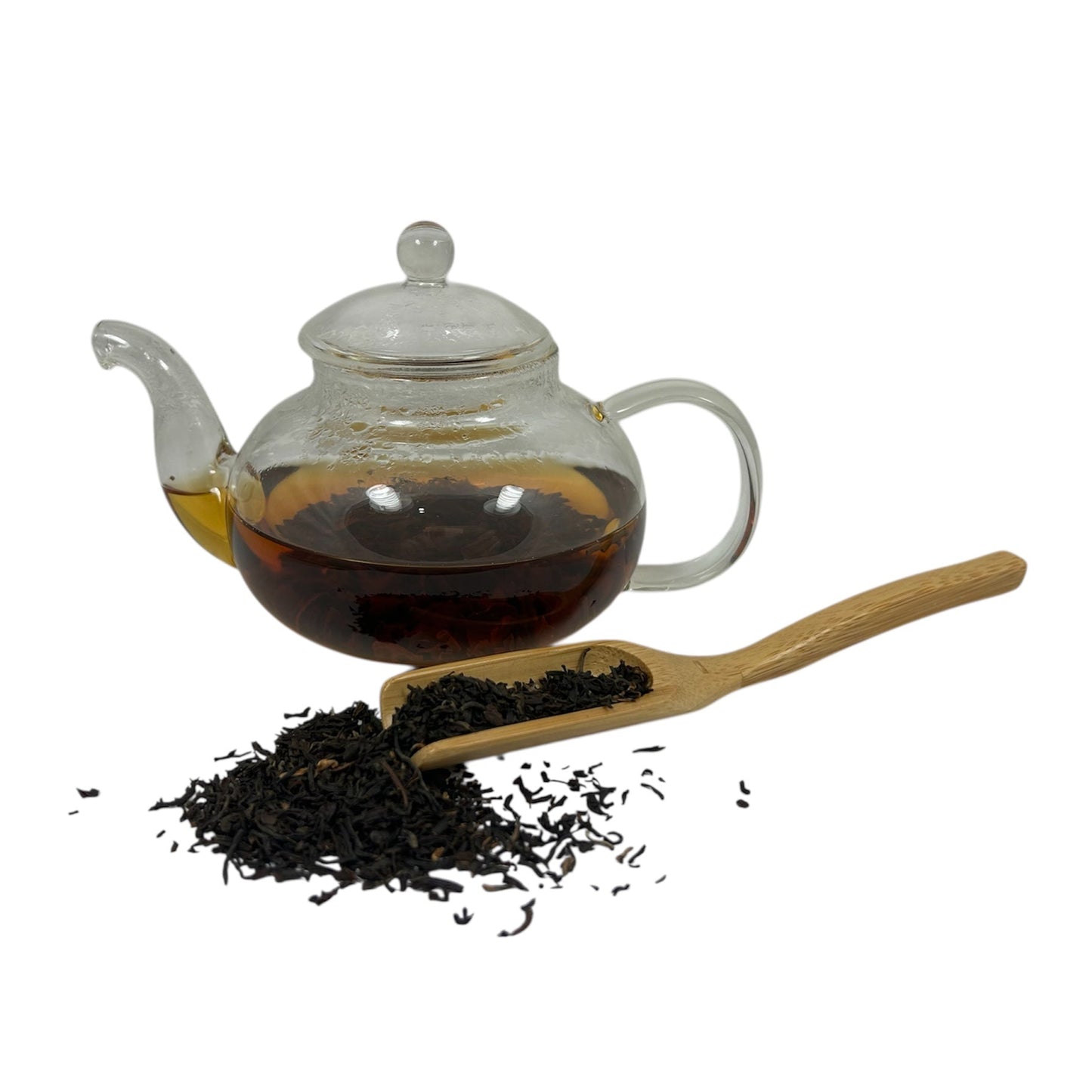 Thé noir assam dans ne théière avec feuilles de thé en vrac
